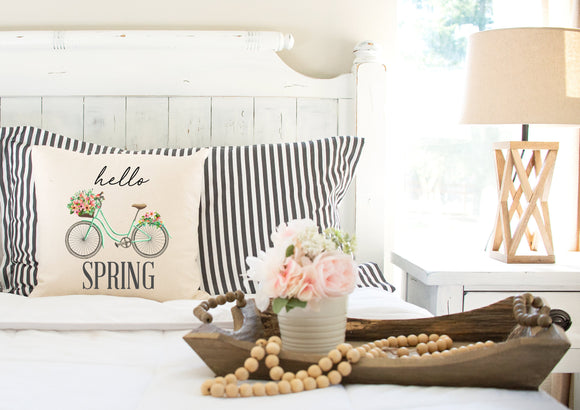 Decorative pillow cover hello spring arranged on bed