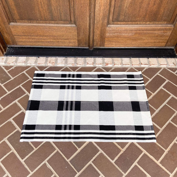Black and white plaid modern farmhouse rug on front porch