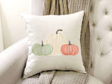 Pumpkin Trio pillow cover displayed on chair 18 by 18 inches