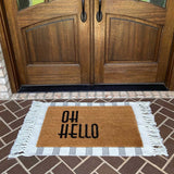 White with black vertically grouped stripes entry rug displayed on porch under grass door mat