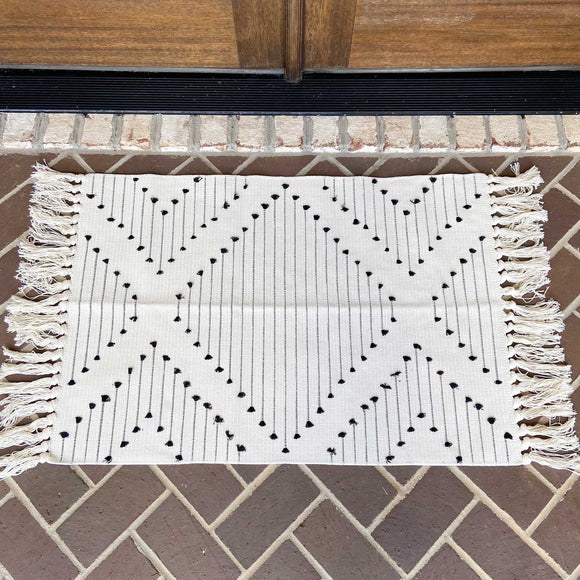 Woven Decorative Indoor Rug 36x24 inches with White and Black Tassle Pattern on Porch